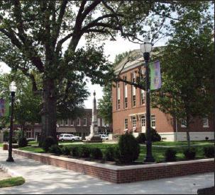 The old and new now peacefully co-exist on the square, where this centuries-old aok tree graces the courthouse lawn, surrounded by a new brick wall with concrete capstones designed by Ben Page.