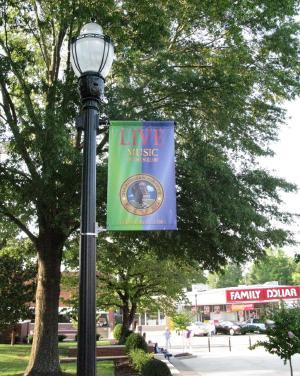 the new plamstands downtown, fashioned to look old, proudly display banners promoting the weekly Music on the Square events, which showcase local talent.